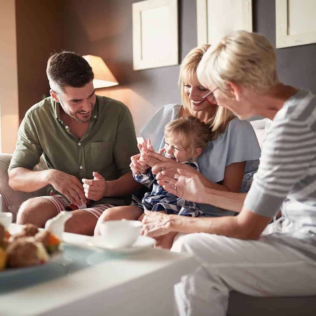 Family enjoying breakfast together in a cozy home setting.