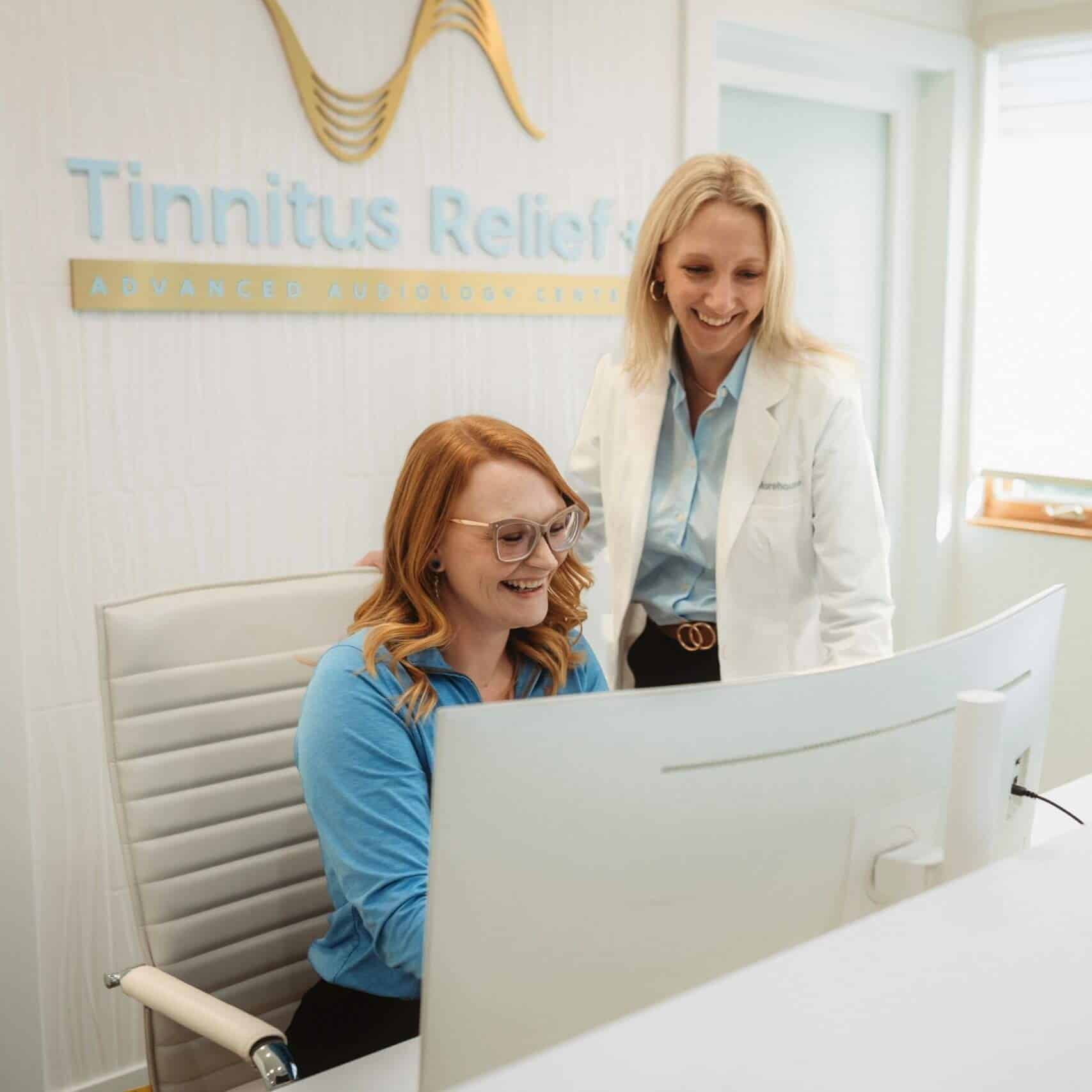 Audiologist assisting a patient at Tinnitus Relief + Advanced Audiology Center.
